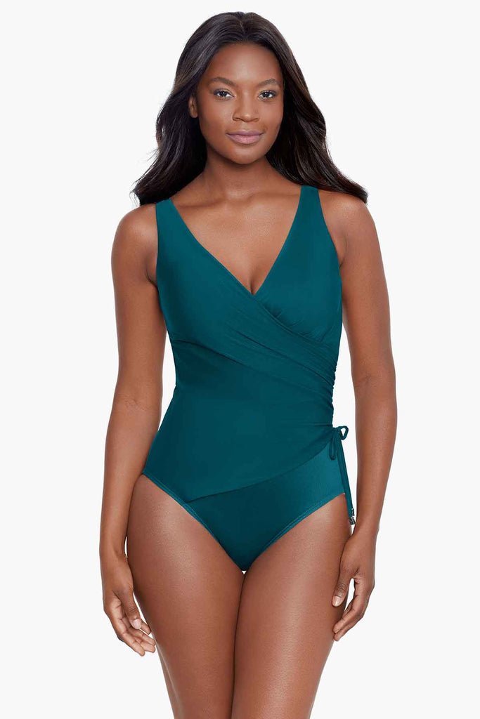 Woman wearing full coverage one piece swim suit.