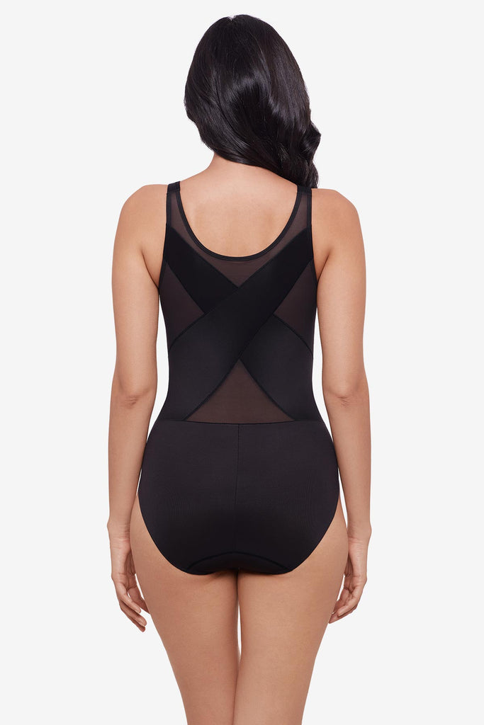 Woman faced away wearing black one-piece shapewear 
