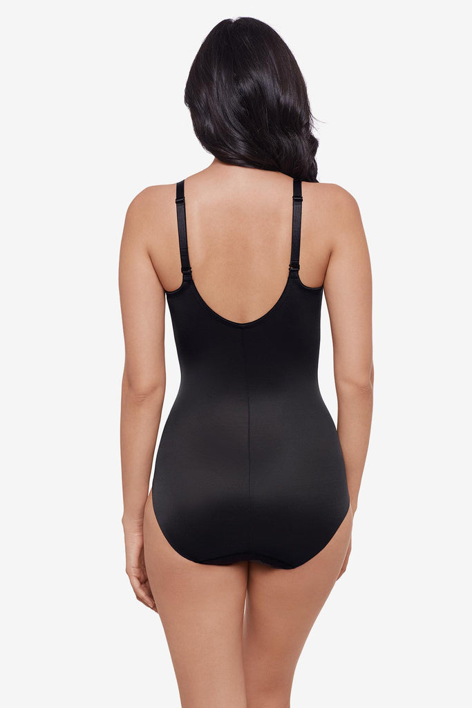 Woman faced away wearing black one-piece shapewear