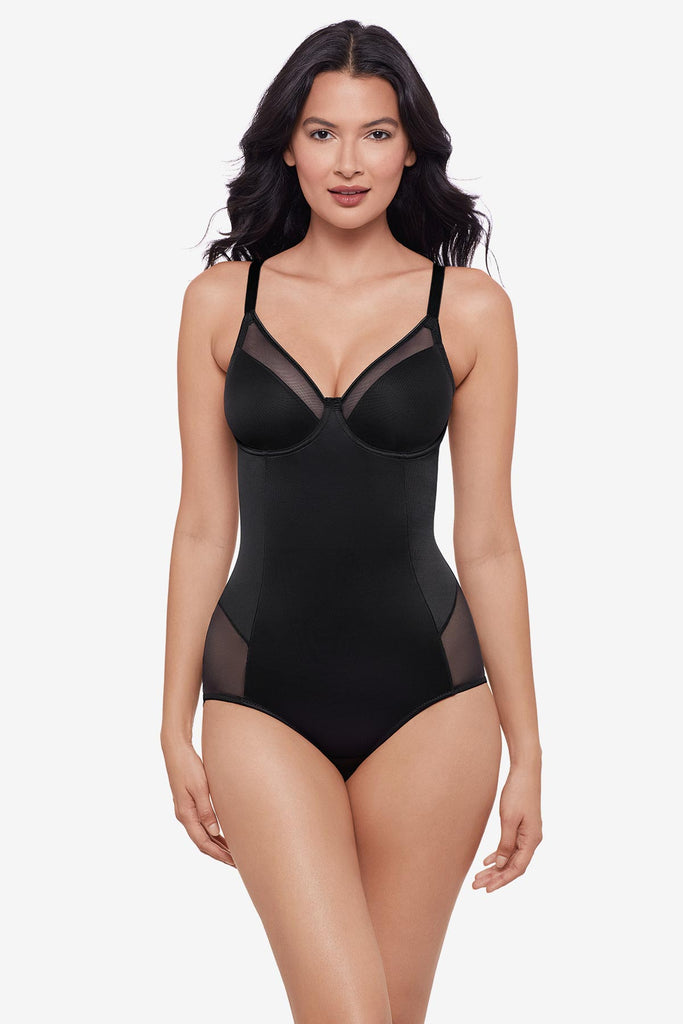Woman wearing black one-piece shapewear