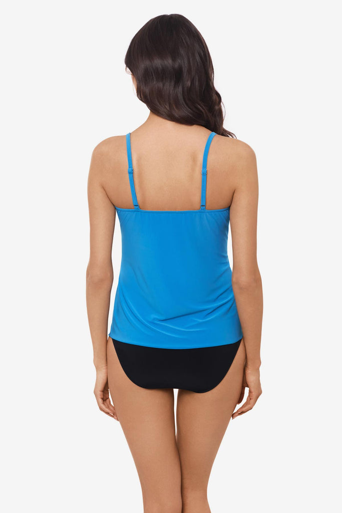 Woman facing away wearing a light blue tankini top