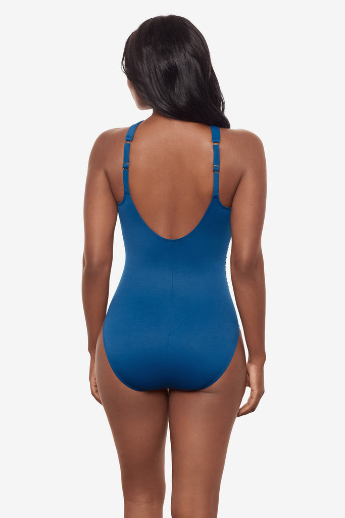 Woman turned away wearing a blue one-piece swimsuit