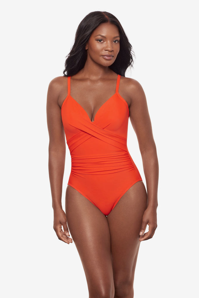 Woman wearing an orange one-piece swimsuit with a sweetheart neckline