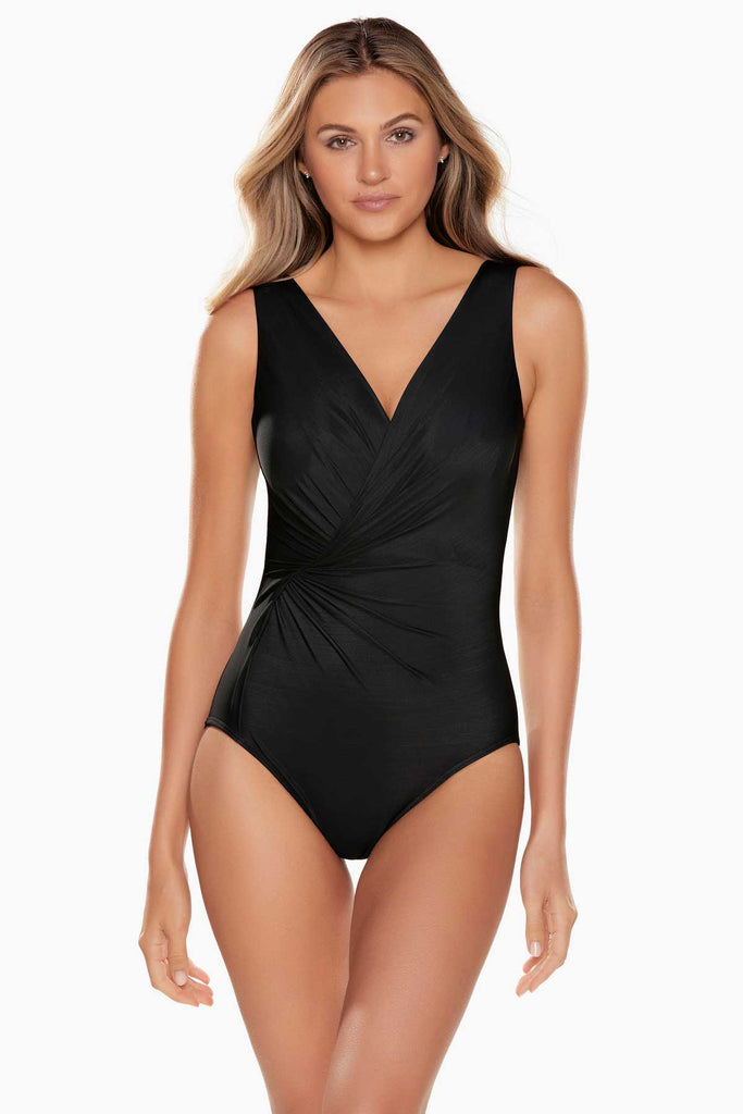 Woman looking beautiful in a one piece swim suit.