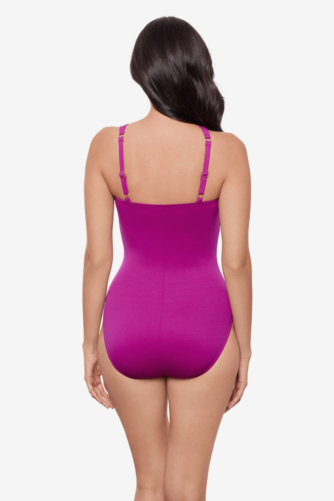 Woman faced away wearing a magenta one-piece swimsuit
