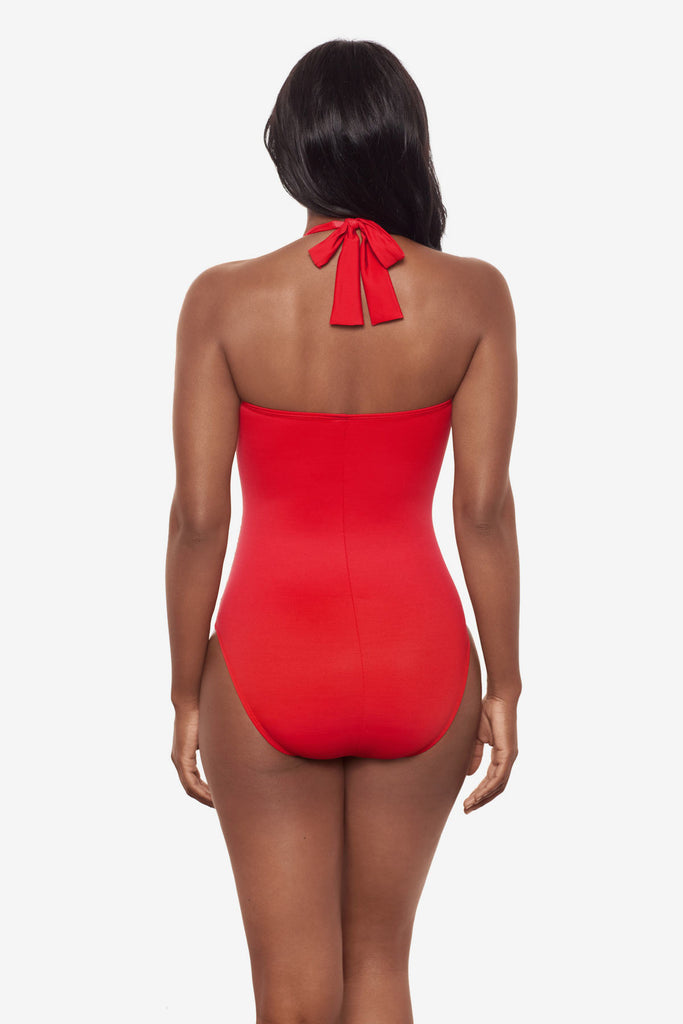 Woman turned away wearing a red orange one-piece halter tie swimsuit