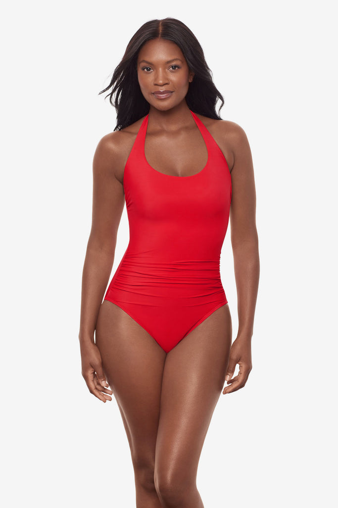 Woman wearing a red orange one-piece halter tie swimsuit