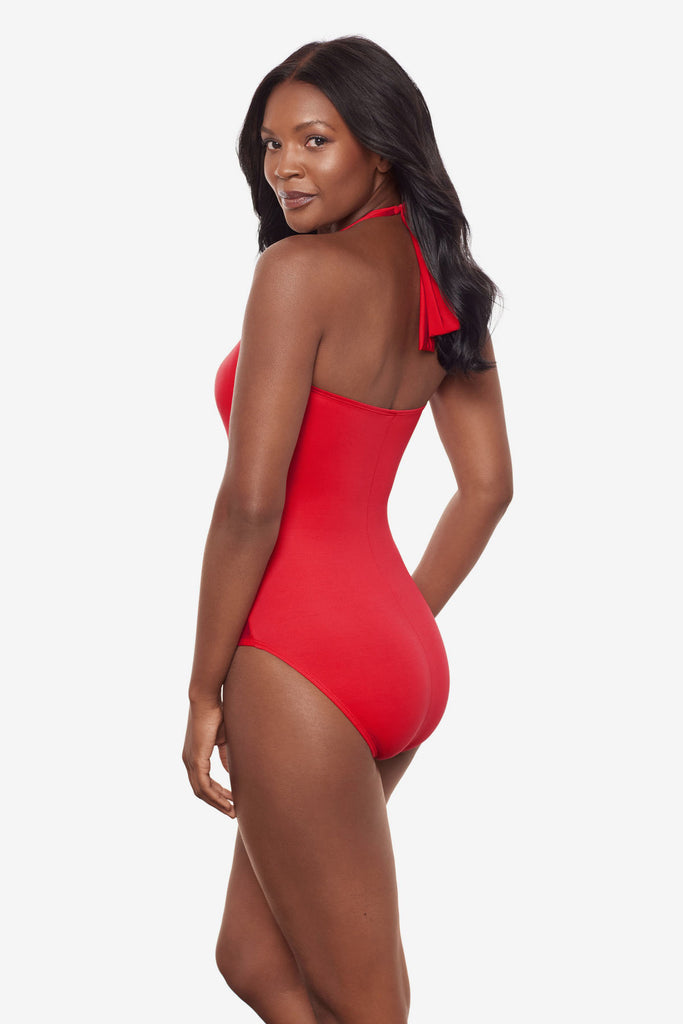 Woman turned left wearing a red orange one-piece halter tie swimsuit