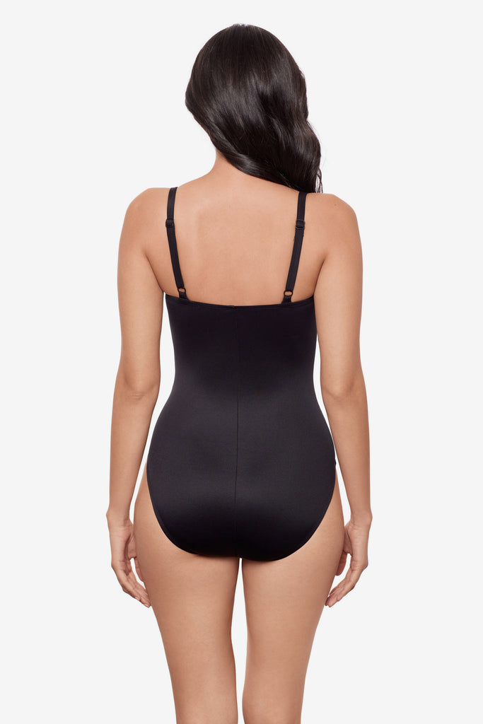 Woman wearing a color block one-piece swimsuit
