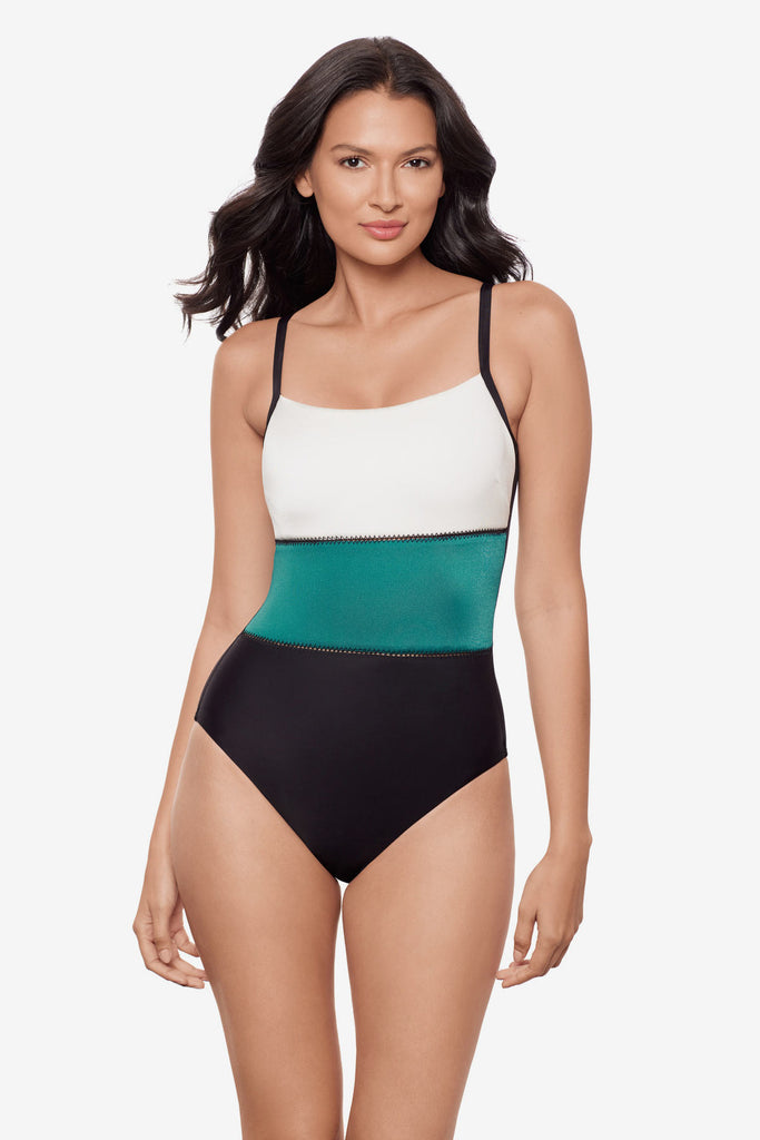 Woman wearing a white, blue and black color block one-piece swimsuit