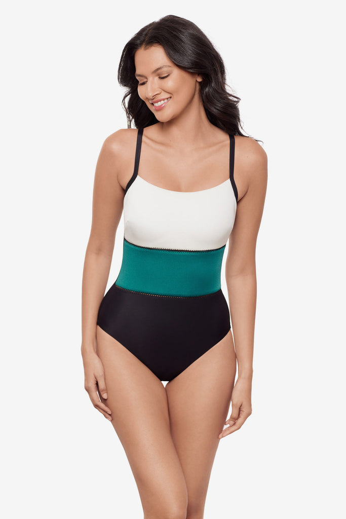 Woman wearing a white, blue and black color block one-piece swimsuit