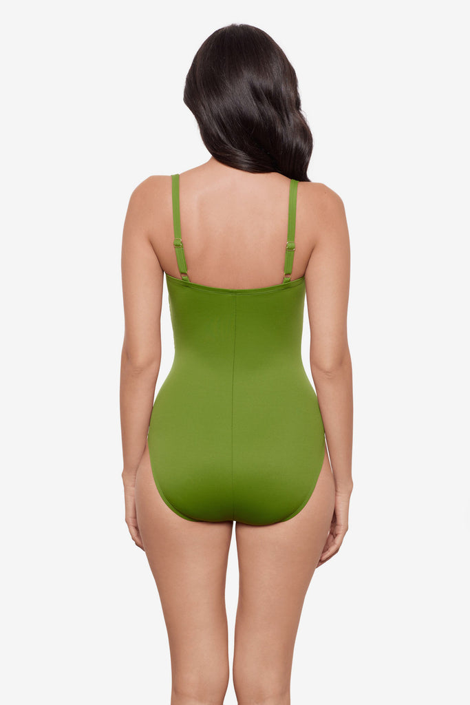 Woman turned away wearing a bright green one-piece swimsuit