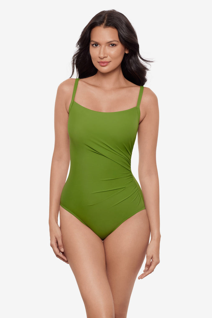Woman wearing a bright green one-piece swimsuit