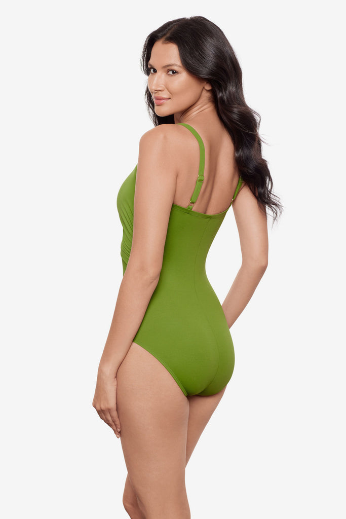 Woman turned left wearing a bright green one-piece swimsuit