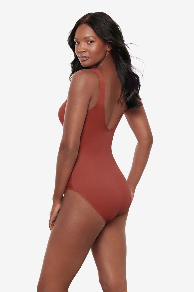 Woman turned left wearing a brown high neck one-piece swimsuit
