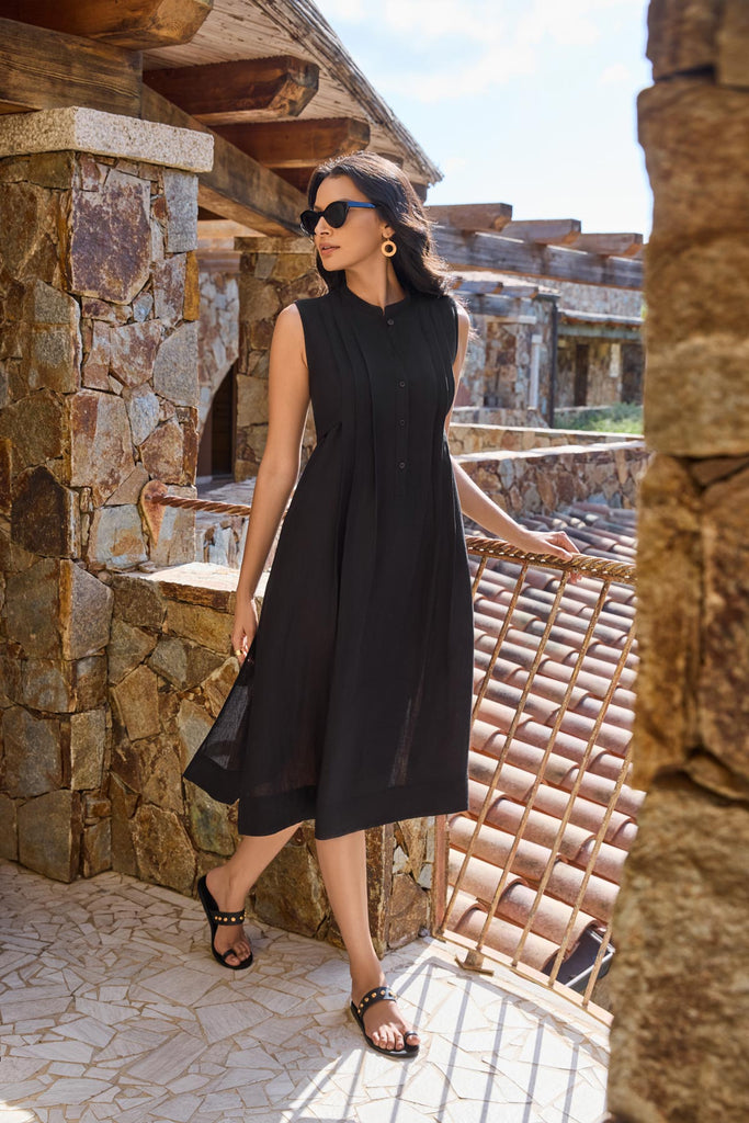 Woman near balcony wearing a black swim dress cover up