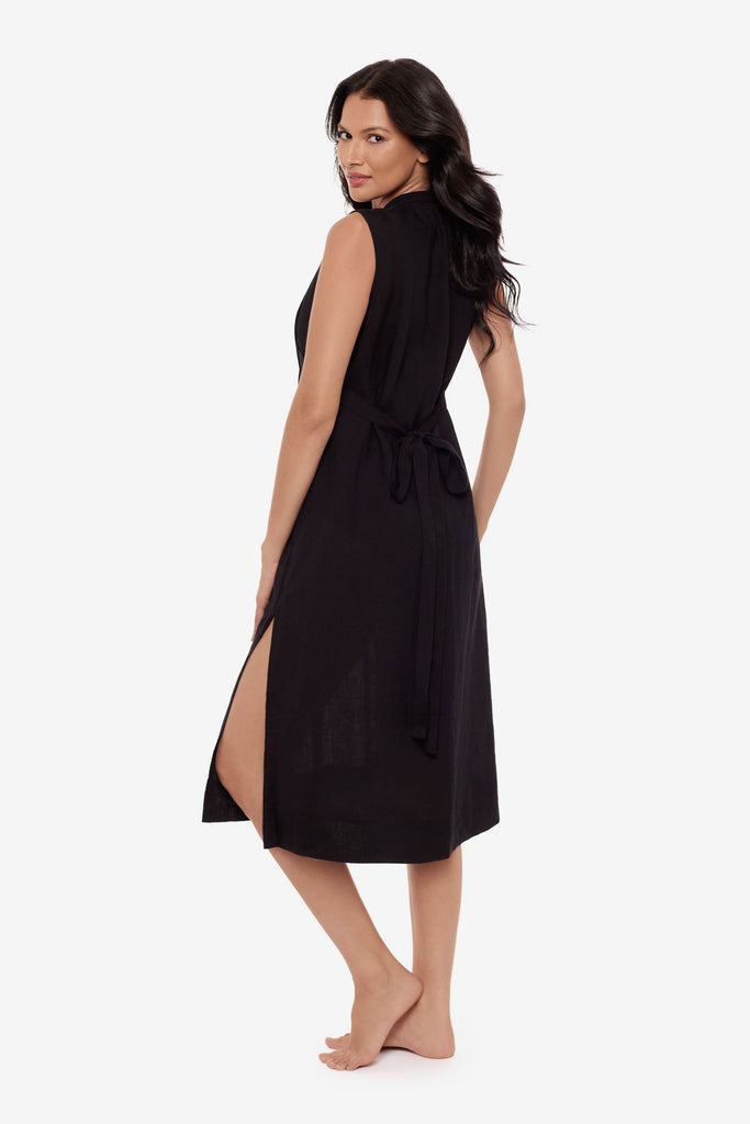 Woman turned left wearing a black swim dress cover up