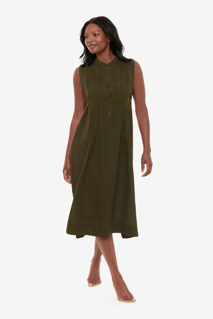 Woman wearing a dark green swim dress cover up