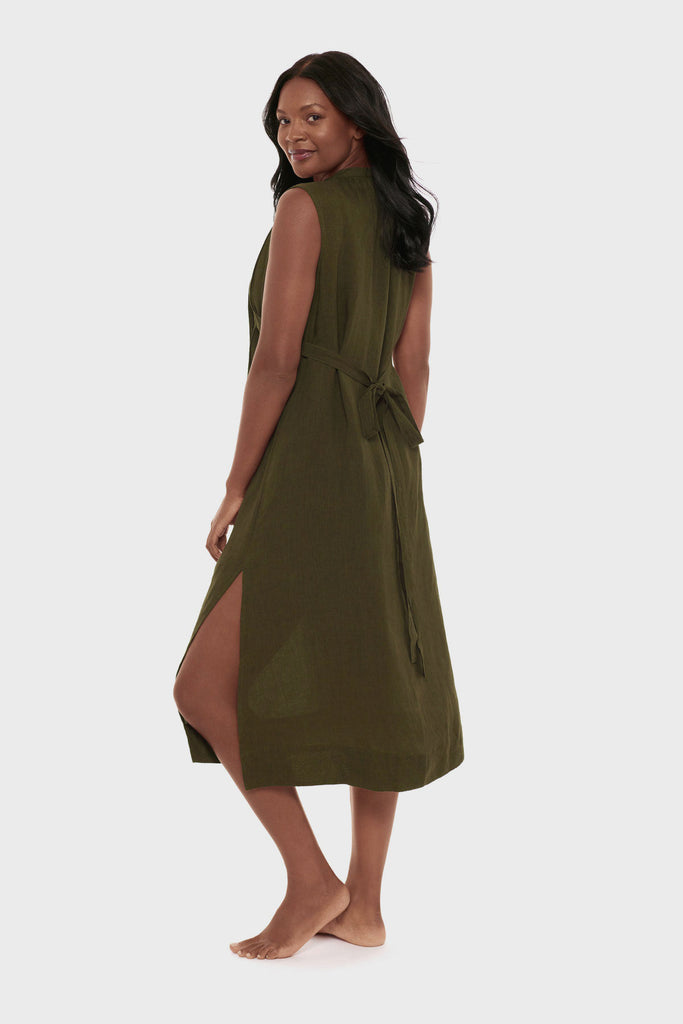 Woman turned left wearing a dark green swim dress cover up