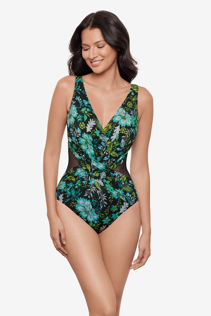 Woman wearing a multicolored floral printed one-piece swimsuit with a V neckline