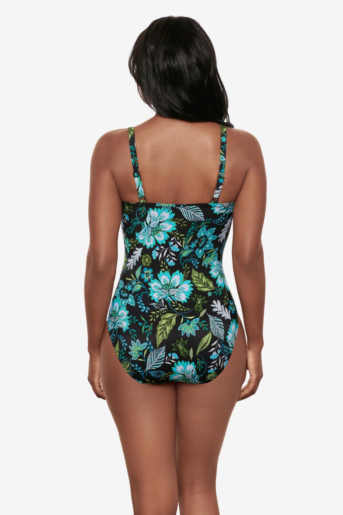 Woman turned away wearing a multicolored floral printed one-piece swimsuit