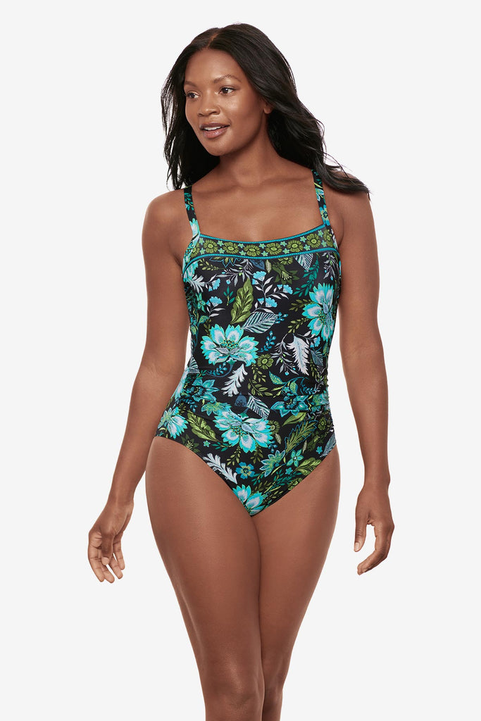 Woman wearing a multicolored floral printed one-piece swimsuit