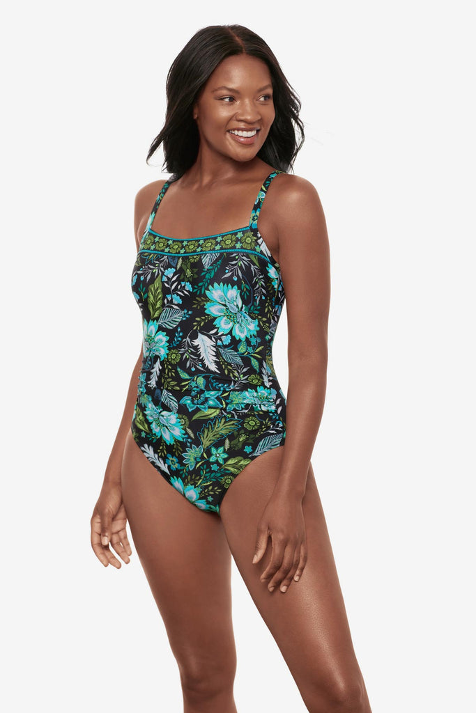 Woman wearing a multicolored floral printed one-piece swimsuit