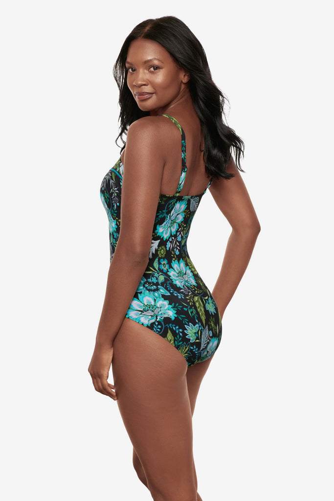 Woman turned left wearing a multicolored floral printed one-piece swimsuit