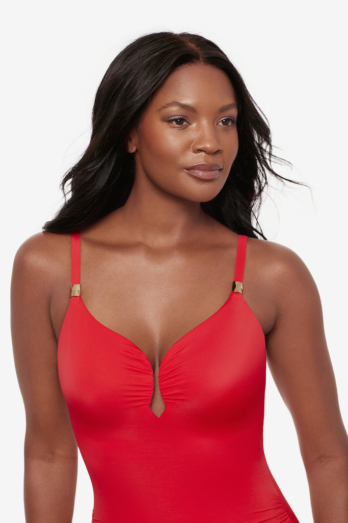 Woman wearing an orange one-piece swimsuit with a sweetheart neckline