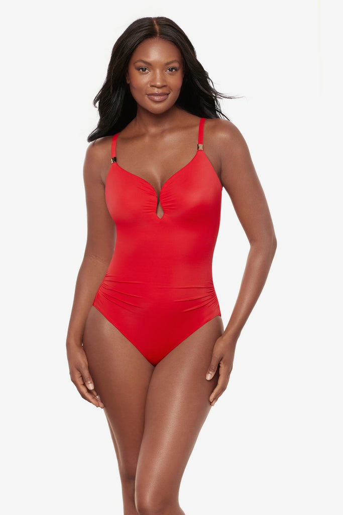 Woman wearing an orange one-piece swimsuit with a sweetheart neckline