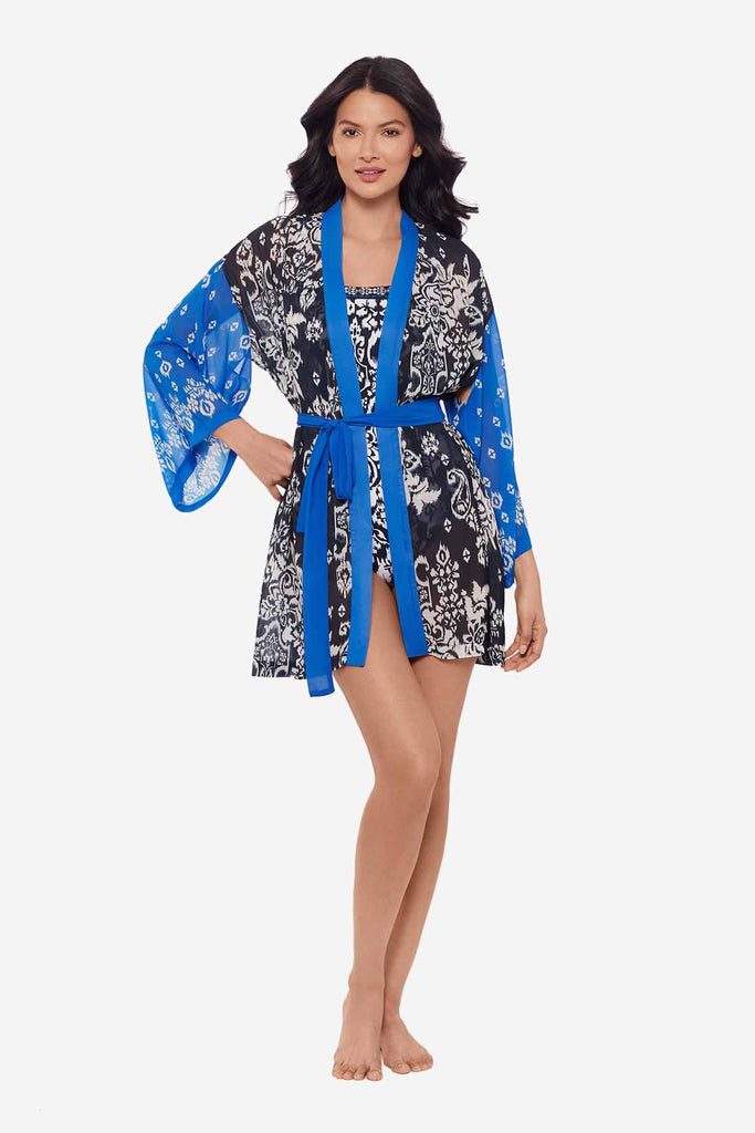 Woman wearing a kimono style swim cover up with white flowers