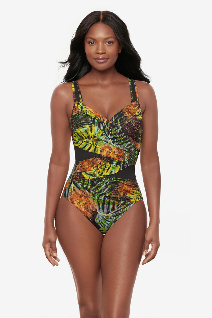 Woman wearing a multicolored palm leaf printed one-piece swimsuit