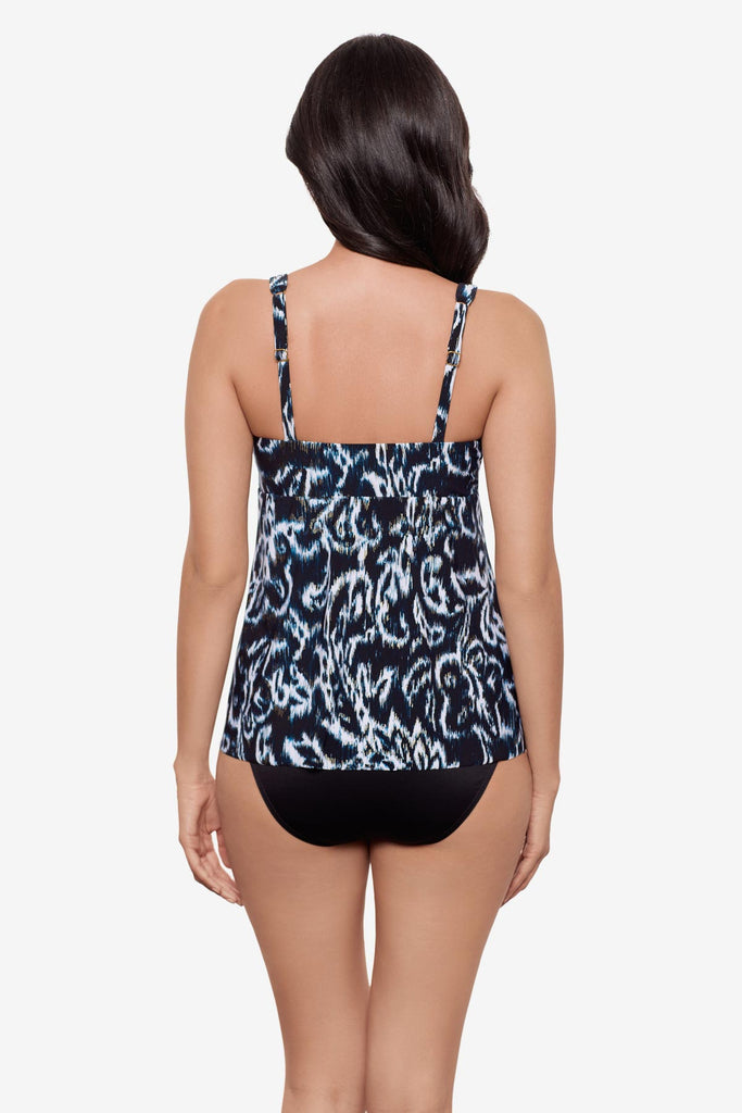 Woman turned away wearing a black and white abstract printed tankini top
