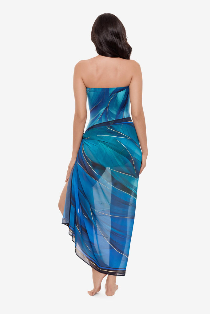 Woman turned away wearing a multi-blue swim cover up with matching swimsuit
