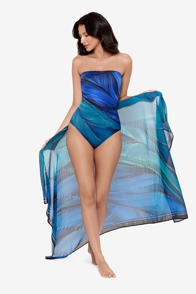 Woman wearing a multi-blue swim cover up with matching swimsuit