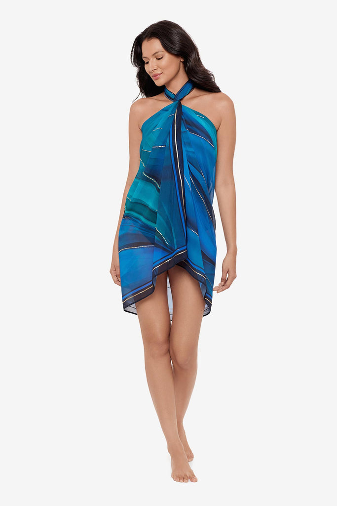 Woman wearing a multi-blue swim cover up with matching swimsuit
