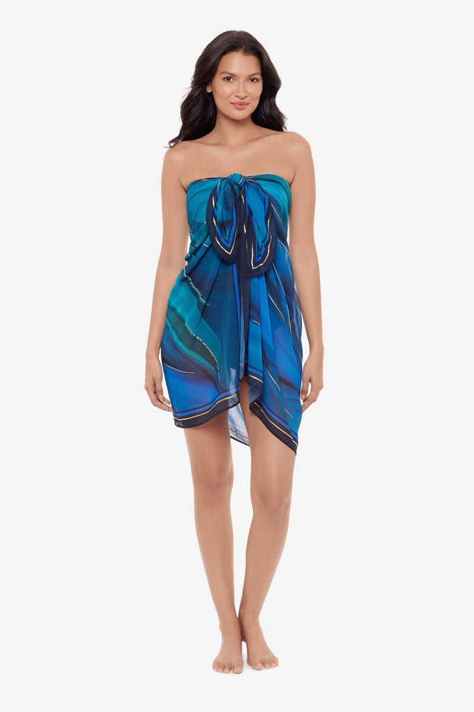 Woman wearing a multi-blue swim cover up with matching swimsuit