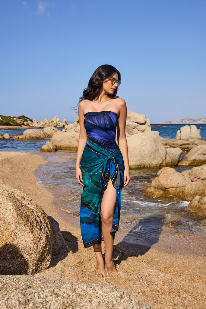 Woman on beach wearing a multi-blue swim cover up with matching swimsuit