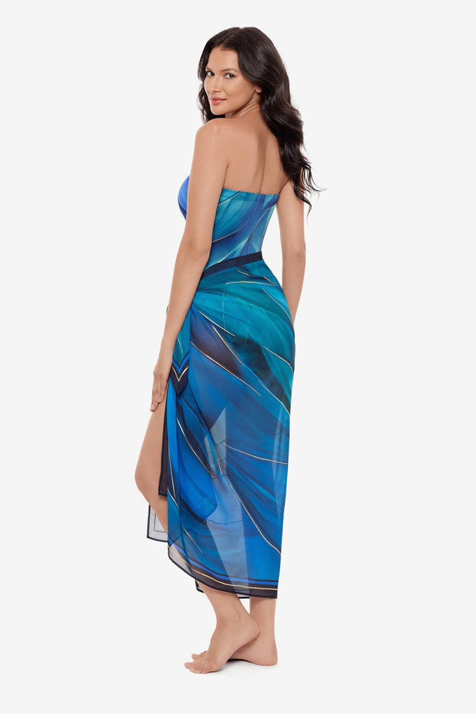 Woman turned left wearing a multi-blue swim cover up with matching swimsuit