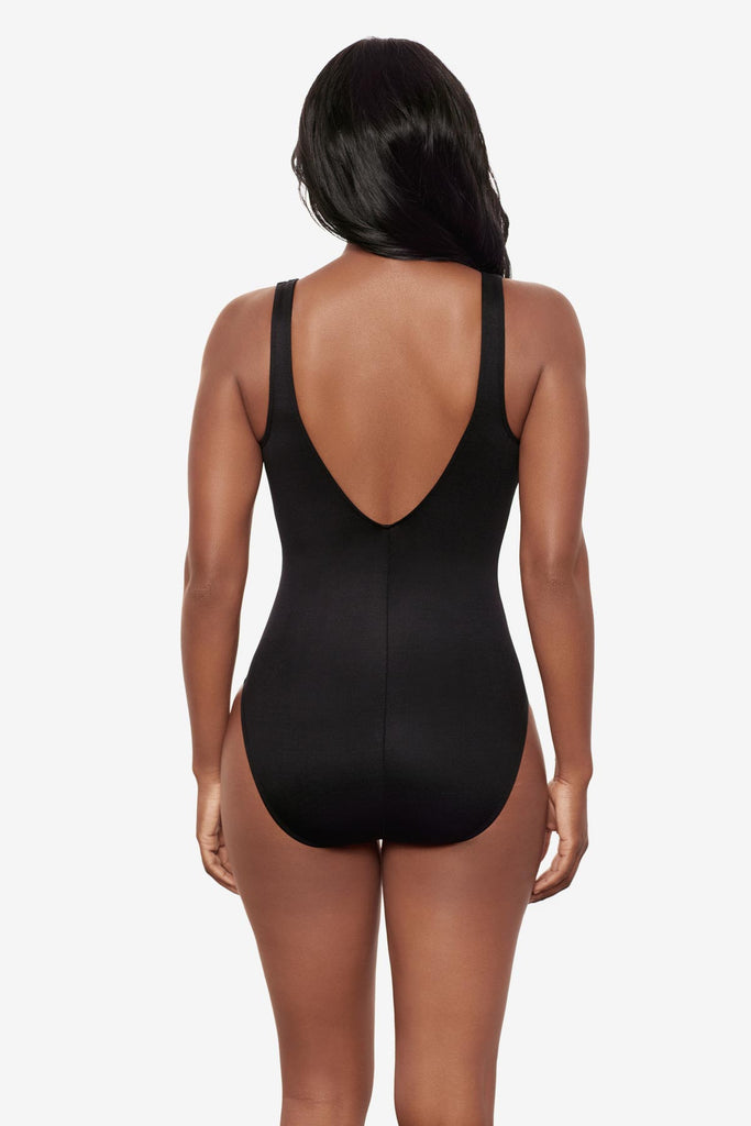 Woman turned away wearing a sparkly black one-piece swimsuit 