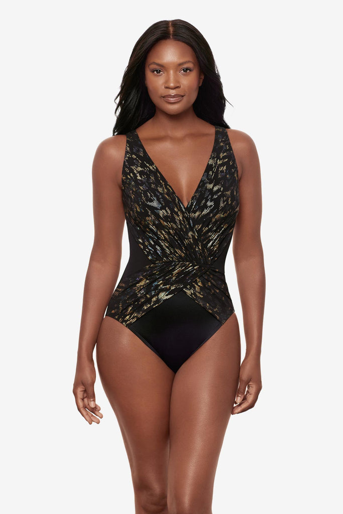 Woman wearing a sparkly black one-piece swimsuit with a V neckline