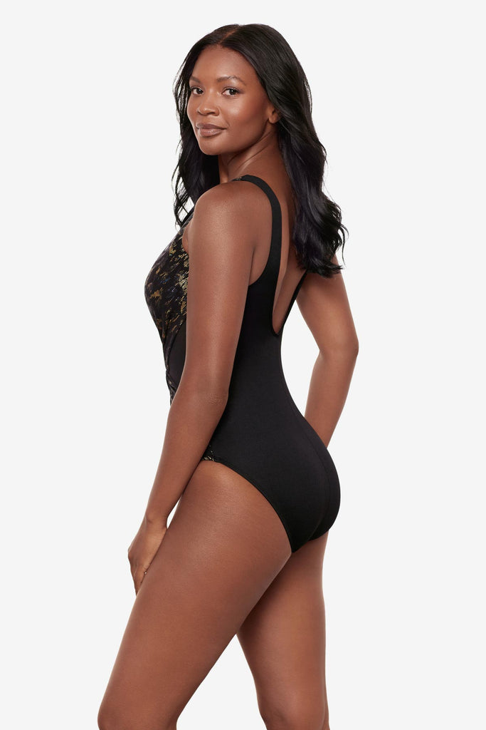 Woman turned left wearing a sparkly black one-piece swimsuit with a V neckline