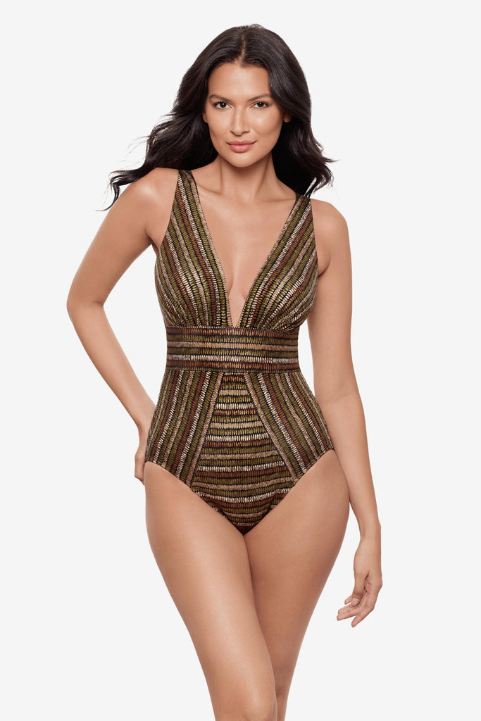 Woman wearing a shimmery golden brown striped one-piece swimsuit with a deep V neck