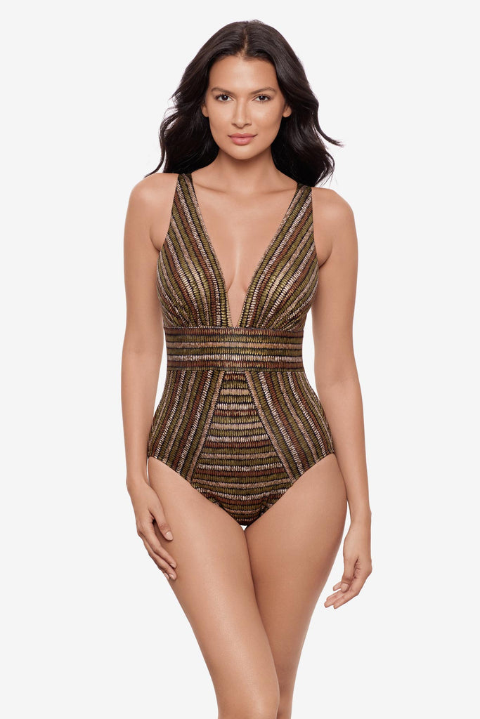 Woman wearing a shimmery golden brown striped one-piece swimsuit with a deep V neck