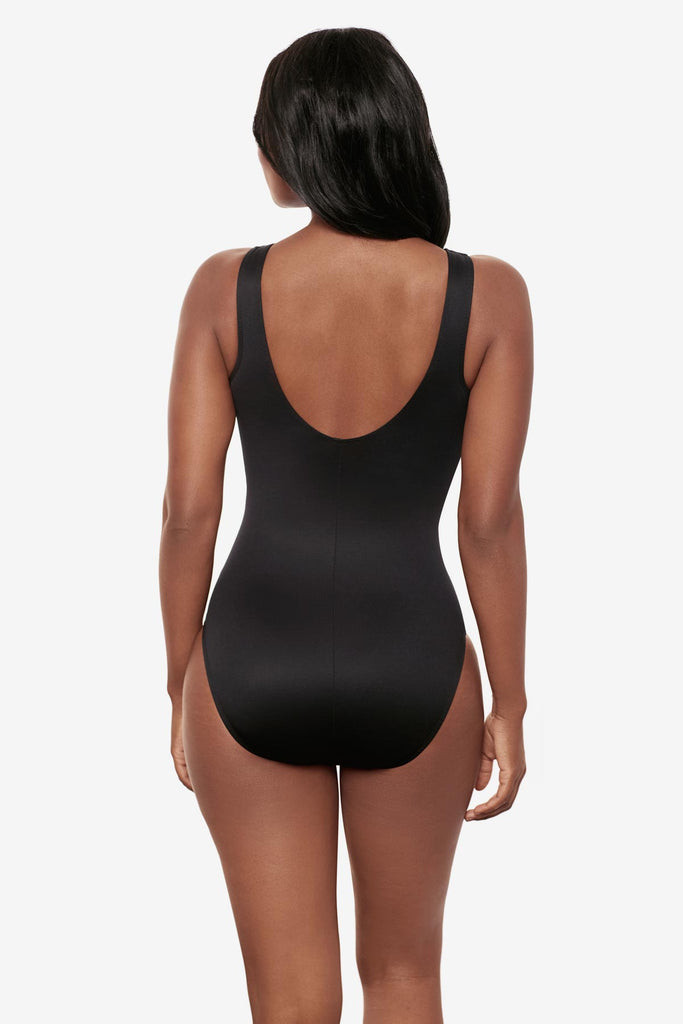 Woman turned away wearing a shimmery golden brown high neck one-piece swimsuit