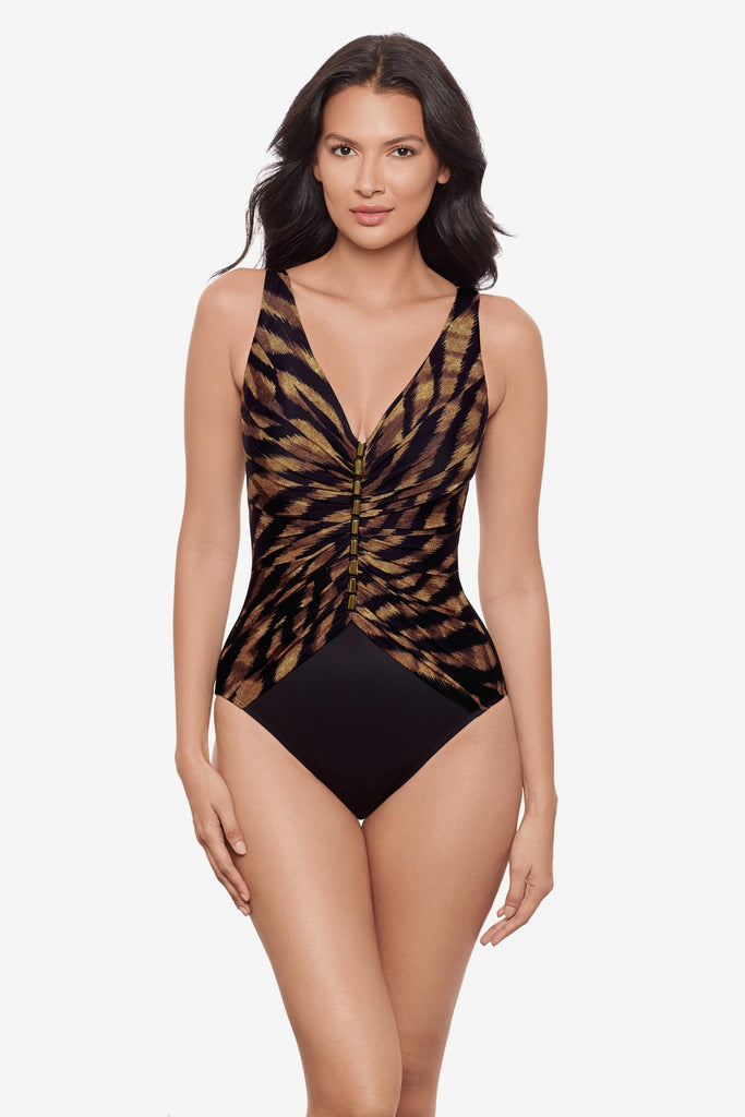 Woman wearing a black and brown printed one-piece swimsuit