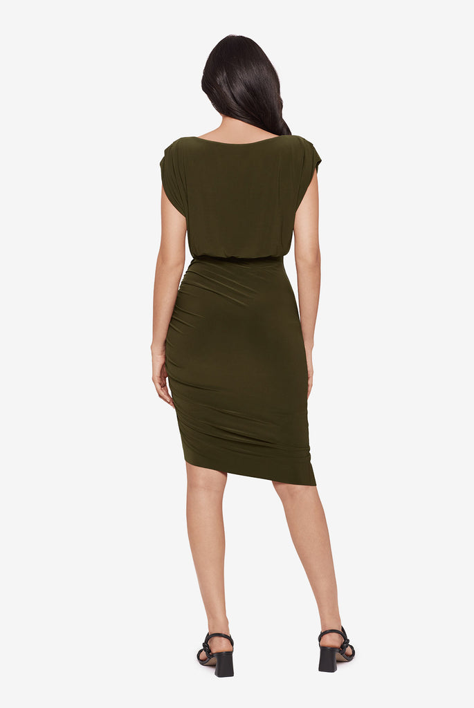Woman turned away wearing a short sleeve mid length dress in nori green