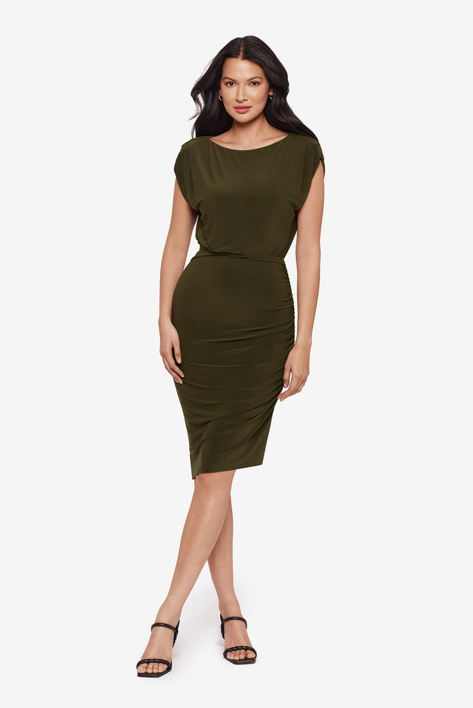 Woman wearing a high neck short sleeve mid length dress in nori green