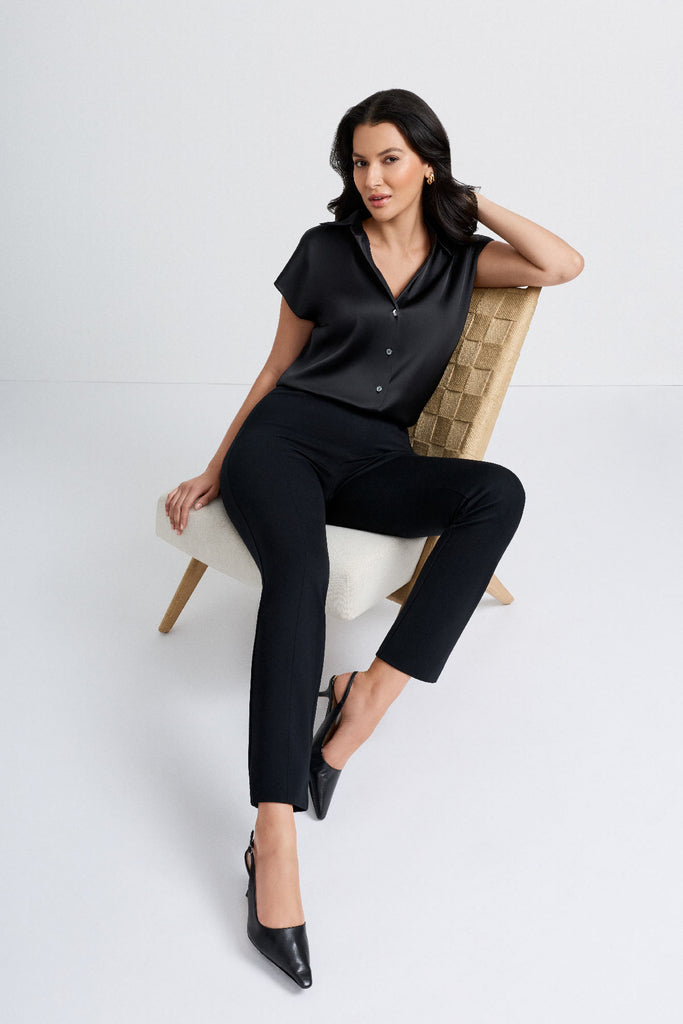 Woman sitting on chair wearing black slim fit pants