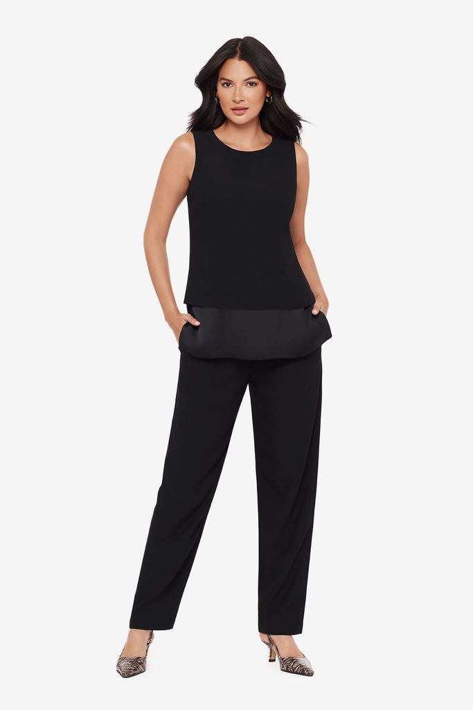 Woman wearing a black layered tunic top with matching jogger pants